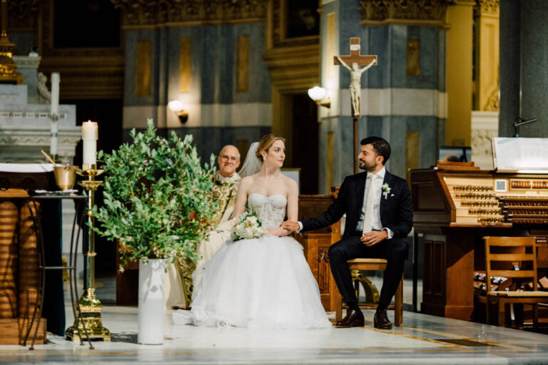 The couple seated at the altar during the church ceremony, from a French couple's wedding in New York, Cottonwood Studios