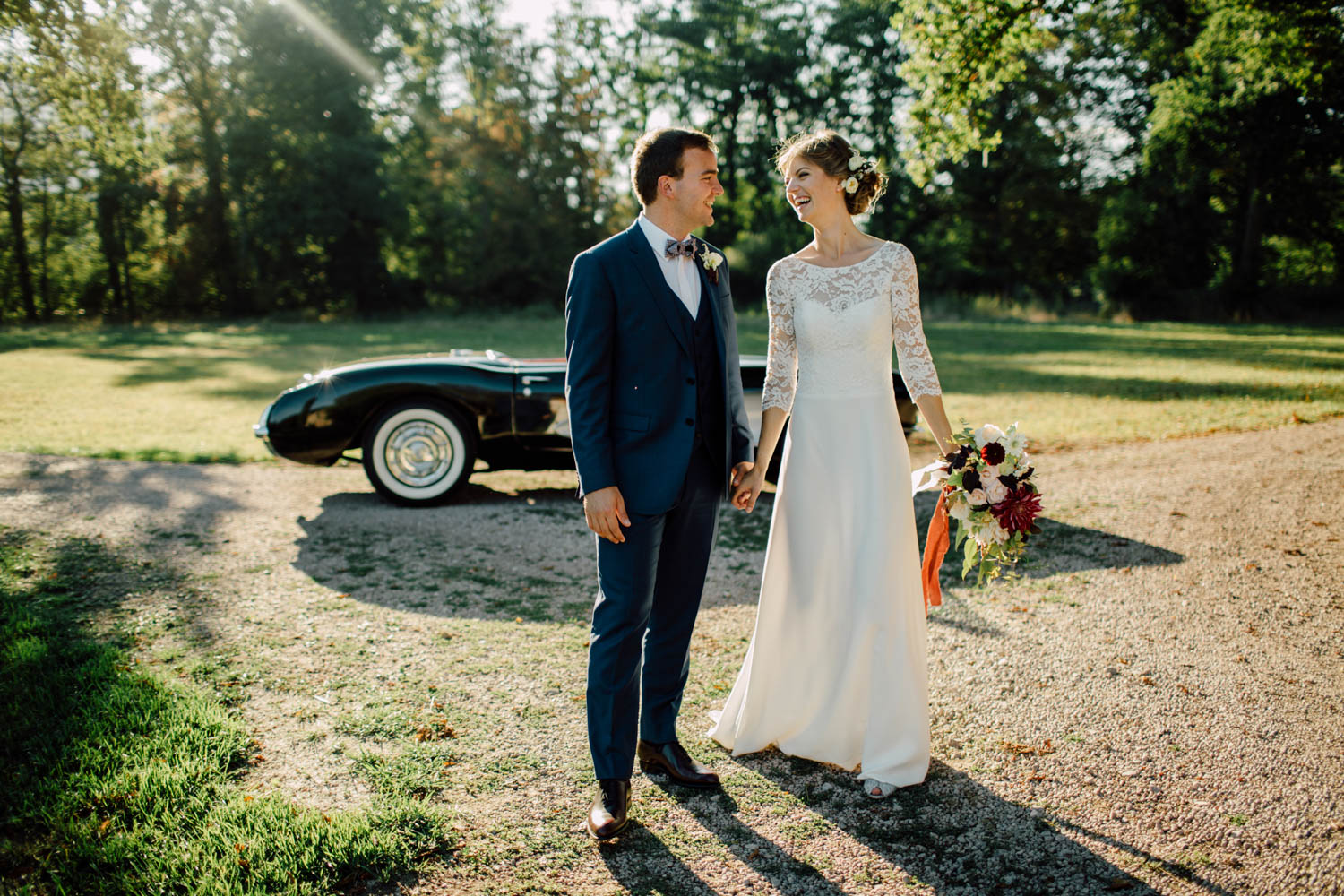 The couple beside a vintage car on the chateau lawn, from a French chateau wedding, Cottonwood Studios