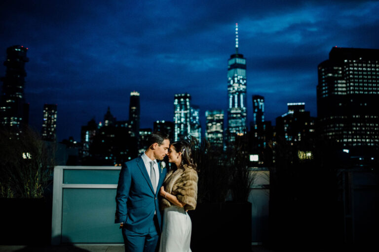 The couple on a Tribeca rooftop at dusk with the Manhattan skyline behind, Cottonwood Studios