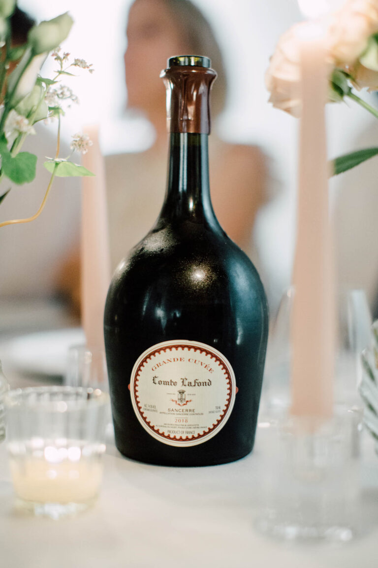 A bottle of Comtesse Lafond champagne on the table, from the Champagne wedding, Cottonwood Studios