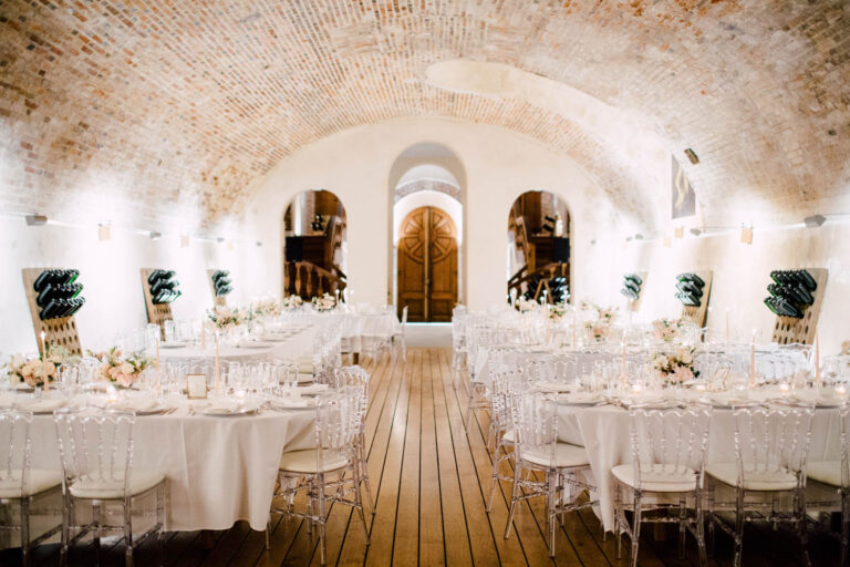A vaulted cellar laid for the wedding dinner, from a wedding at a Champagne house in France, Cottonwood Studios