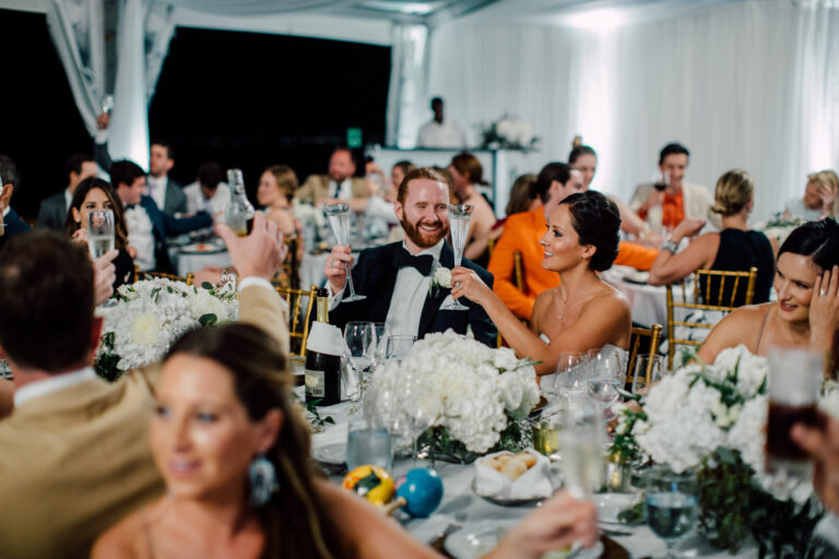 Guests at dinner in a white marquee, from the Caribbean destination wedding, Cottonwood Studios