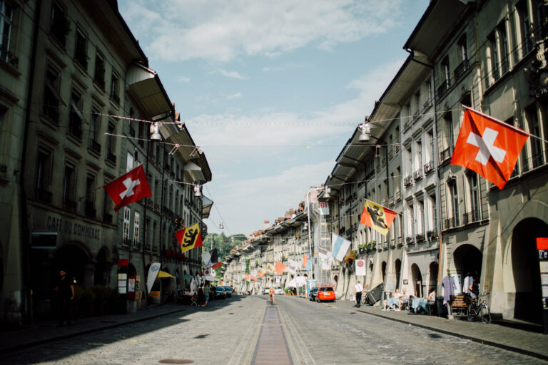 Bern old town street hung with Swiss flags, from a wedding in Bern, Cottonwood Studios
