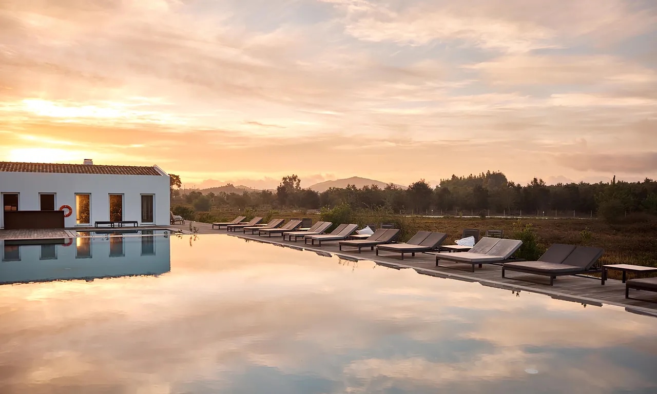 Pool and farmhouse buildings at sunset, Craveiral Farmhouse