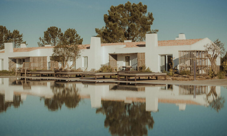 Whitewashed houses reflected in the pool, Craveiral Farmhouse
