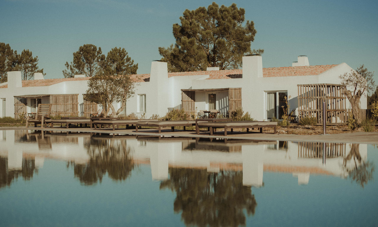 Whitewashed houses reflected in the pool, Craveiral Farmhouse