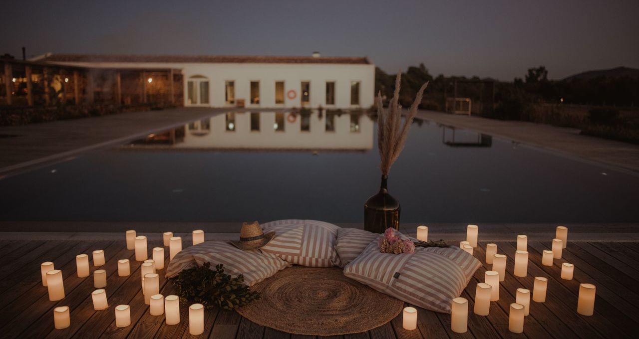 Candlelit pool-side setting at dusk, Craveiral Farmhouse