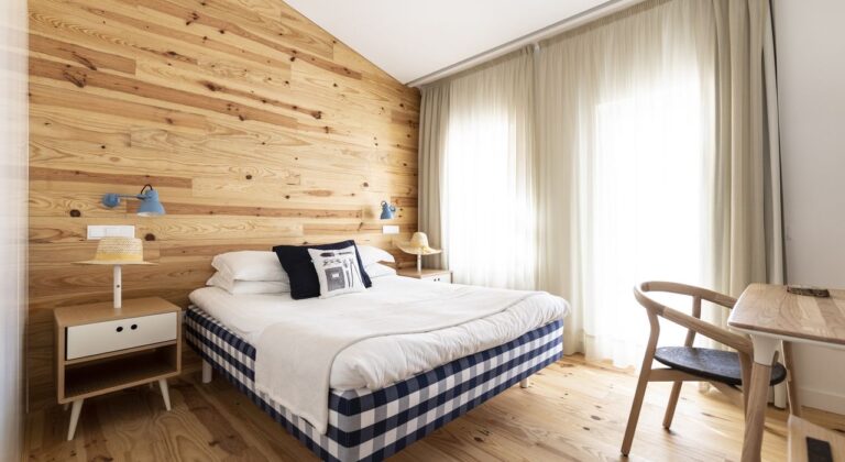 Bedroom with pine-clad wall, Craveiral Farmhouse