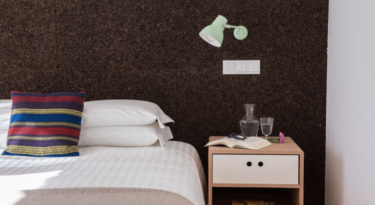 Bedroom with cork wall and striped cushion, Craveiral Farmhouse