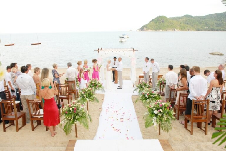 Guests and a petal-strewn white aisle leading to a beach canopy, Creative Events Asia