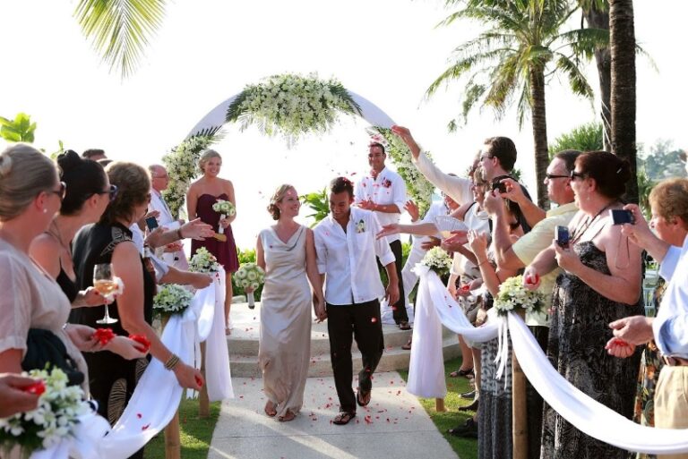 A couple leaving their ceremony through guests throwing petals, Creative Events Asia