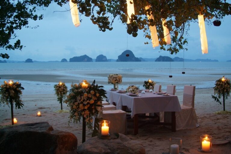 A candlelit wedding table set above the sea at dusk, Creative Events Asia