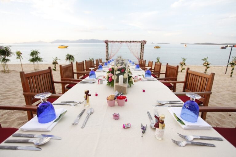 A long table dressed with fresh flowers on the sand, Creative Events Asia