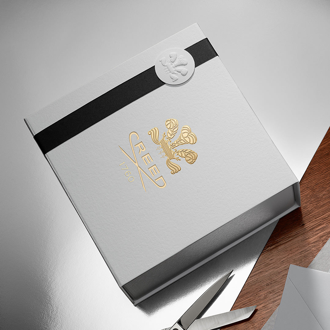 Signature white gift box with black ribbon and embossed seal, Creed