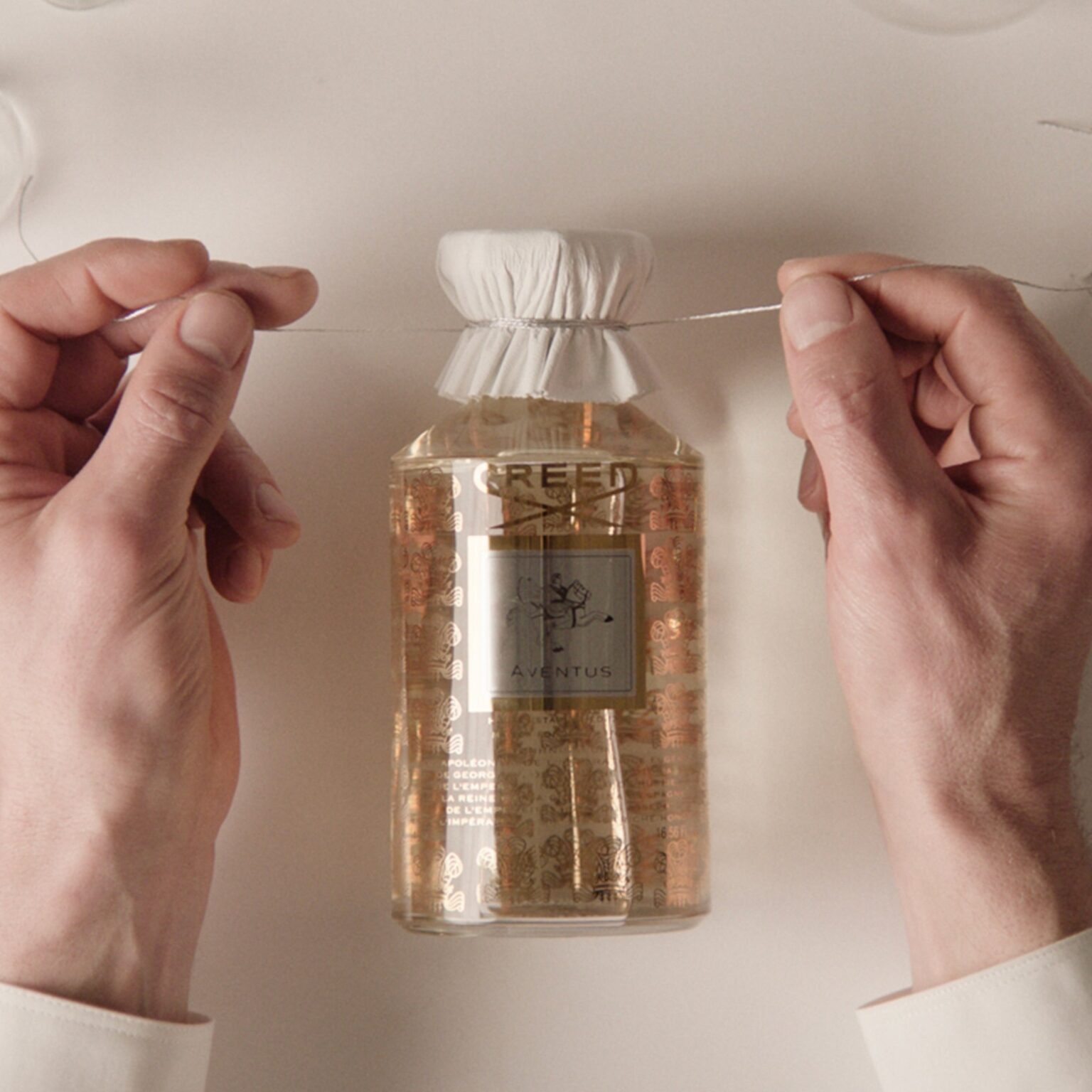 A bottle dressed by hand in the Creed workshop