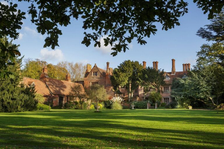 The manor across the lawn, framed by an oak canopy, Creeksea Place
