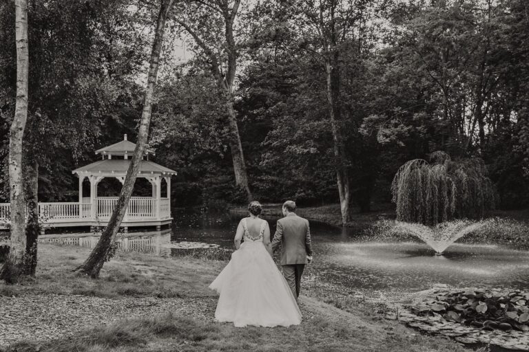 Black and white: the couple walking to the pavilion past the lake fountain, Creeksea Place