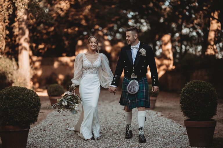 The couple walking the box-lined gravel path in golden light, Creeksea Place