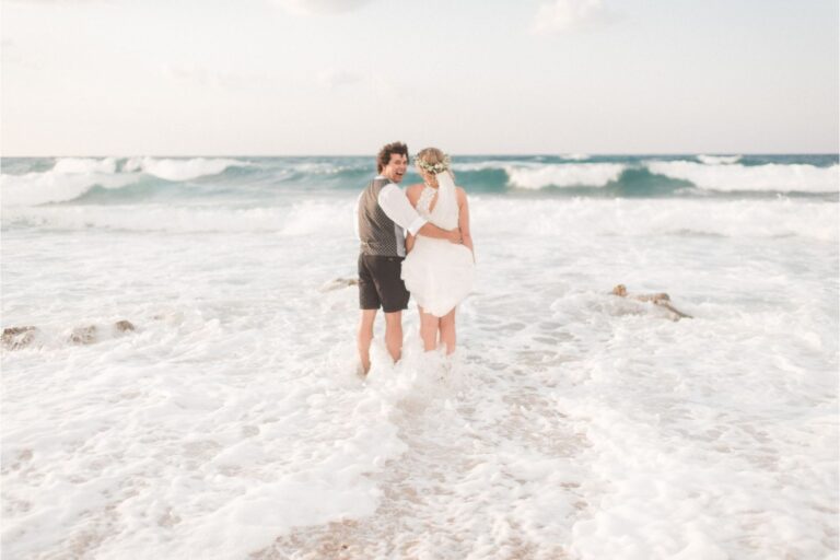 A couple wade into the surf on a beach in Crete, Crete for Love
