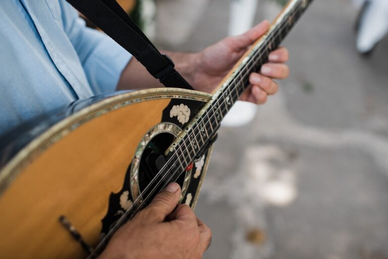 A musician plays a bouzouki at a Greek American wedding, Crete for Love
