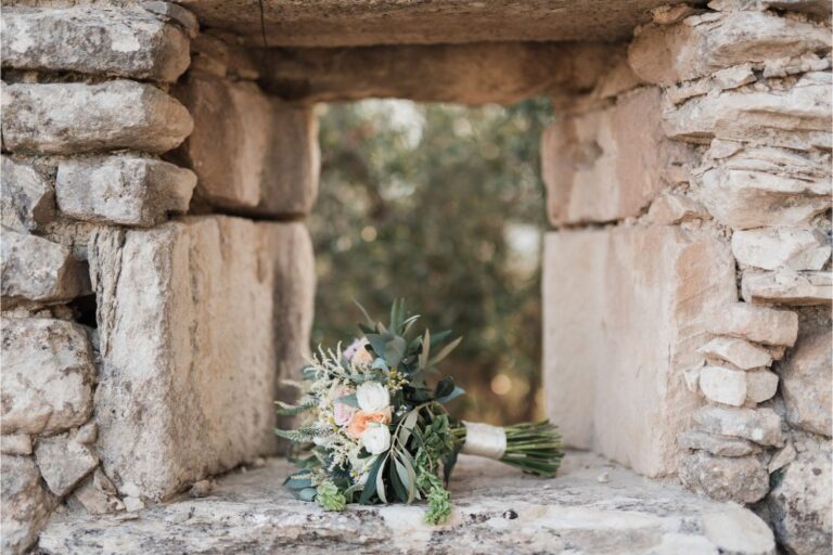 A bridal bouquet set in a stone window opening, Crete for Love