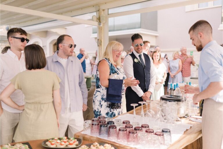 Guests gather around a table of welcome drinks and canapes, Crete for Love