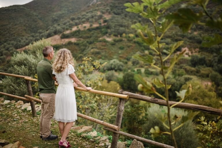 An elopement couple look over a wooded hillside in western Crete, Crete for Love