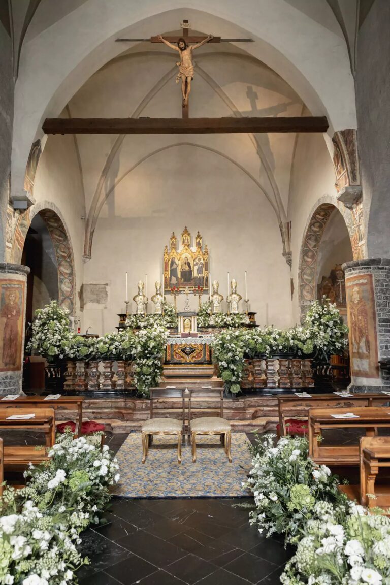 A church interior with white flowers along the aisle and altar, Lake Como, Cristina Verger Event Planning and Production
