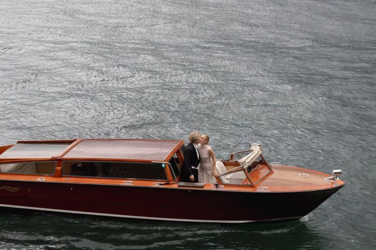 A couple crossing Lake Como in a varnished wooden launch, Cristina Verger Event Planning and Production