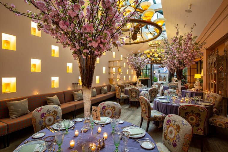 A private dining room with tall cherry blossom arrangements and lavender-clothed tables, New York, Cristina Verger Event Planning and Production
