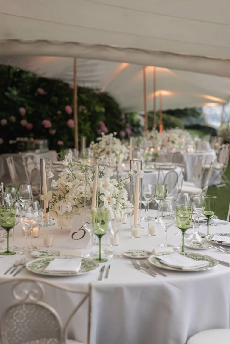 Round table set in white with green glassware under a lakeside tent, Lake Como, Cristina Verger Event Planning and Production