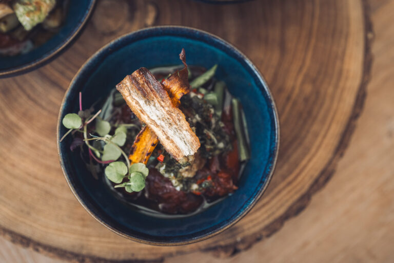 A Ross & Ross dish served in a blue bowl on a wooden board, Crockwell Farm