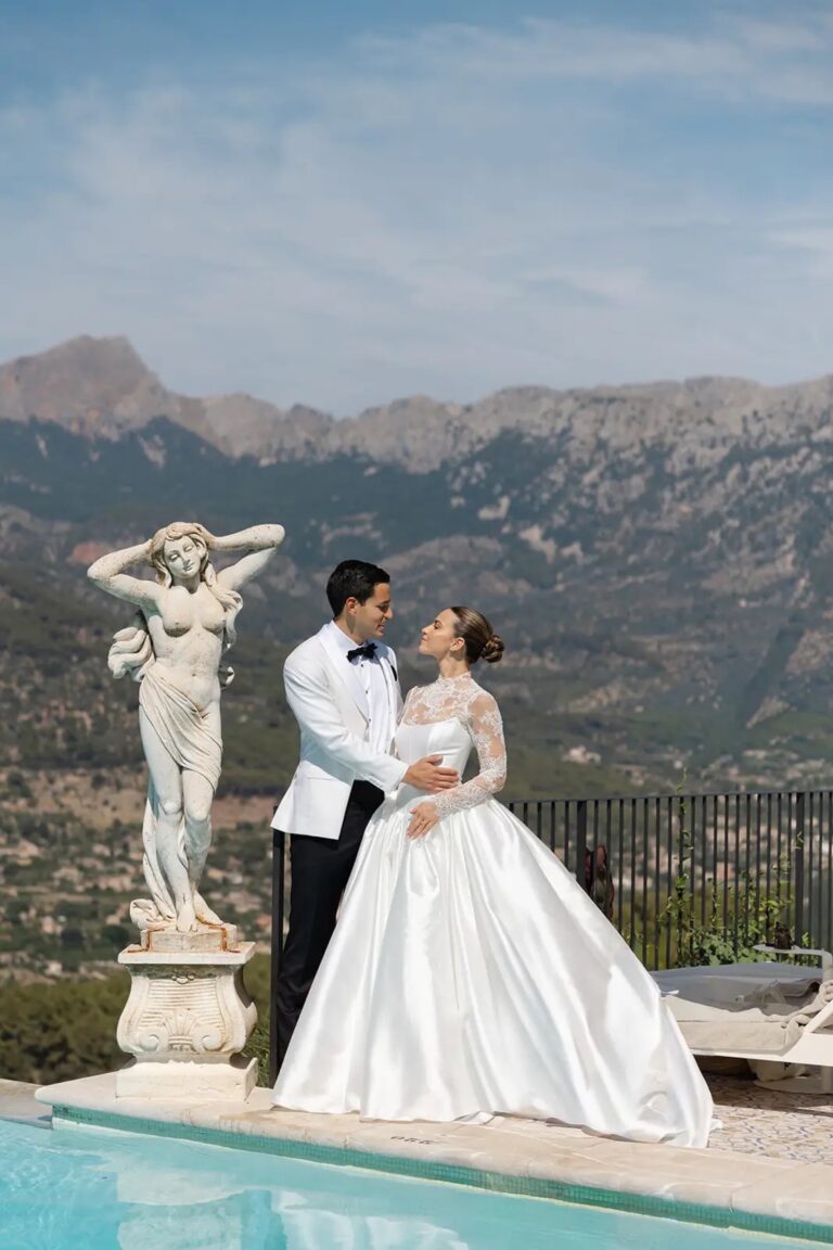 A couple beside a pool and a marble statue with the mountains behind, Cygnus Events