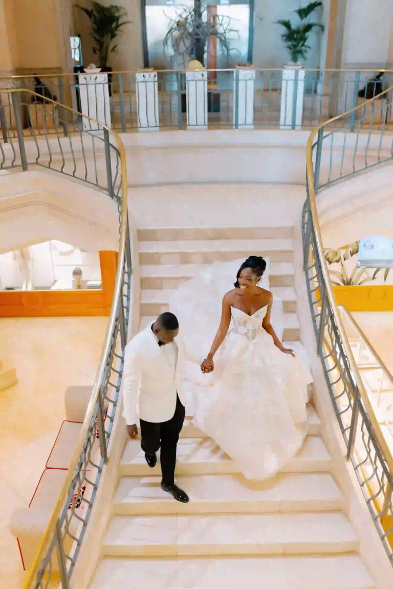 A couple descending a marble staircase, photographed from above, Cygnus Events