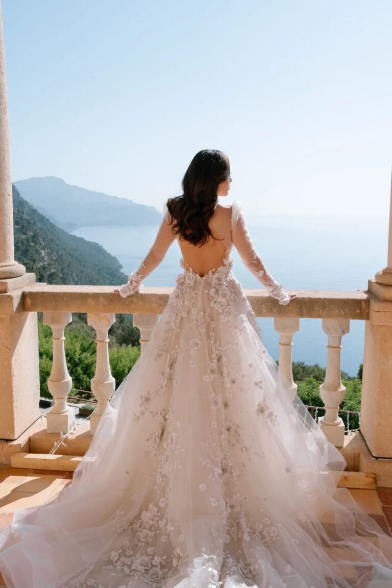 A bride looking out over a stone balustrade to the coast, Cygnus Events