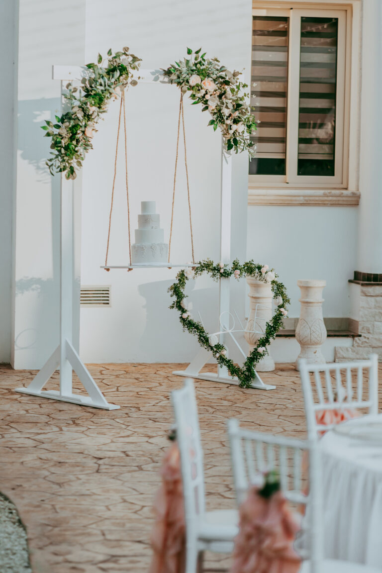 Floral arches, a swing and a heart hedge at a whitewashed villa, Cyprus Wedding Touches