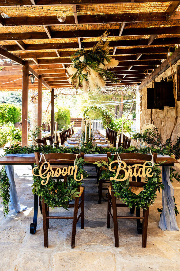 Groom and Bride chair signs with foliage on a rustic table, Cyprus Wedding Touches