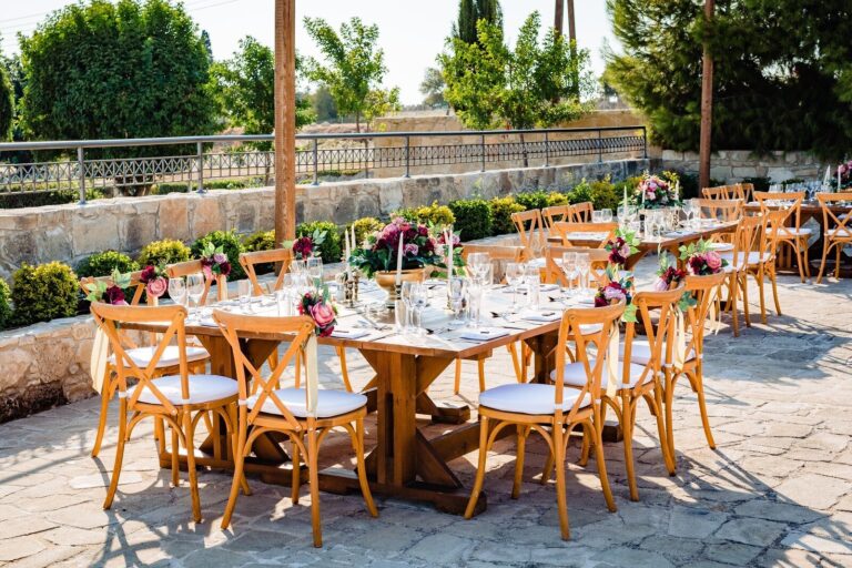 Wooden cross-back chairs and long tables on a terrace, Cyprus Wedding Touches