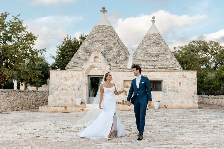 A couple walking in front of the trulli at Masseria Grieco, Puglia, Daniele Vertelli Photography