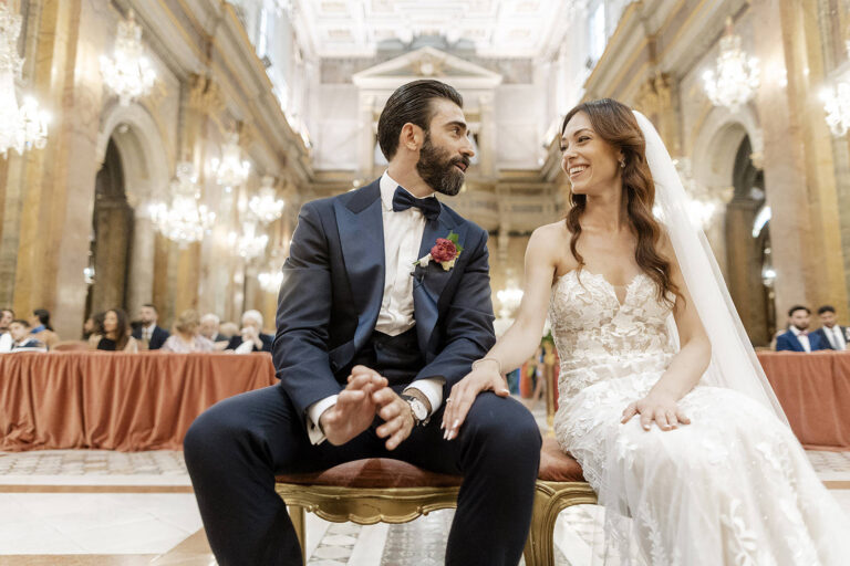 Bride and groom seated in a gilded hall in Rome, sharing a look, Daniele Vertelli Photography