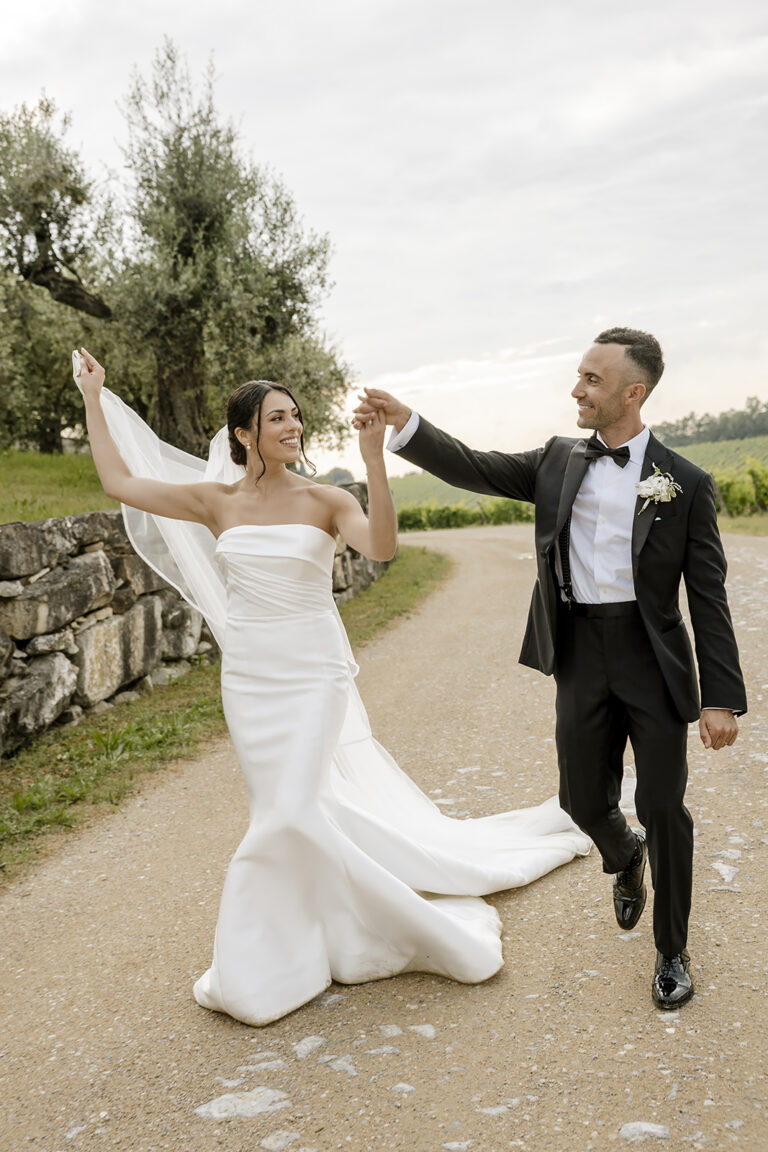 Morgan and Yoel dancing along a gravel road at Castello di Gabbiano, Chianti, Daniele Vertelli Photography