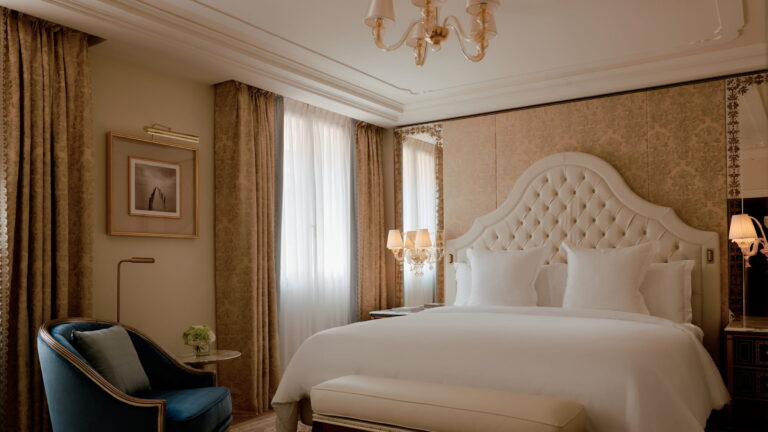 Bedroom with tufted headboard and Murano chandelier, Danieli, Venezia, A Four Seasons Hotel