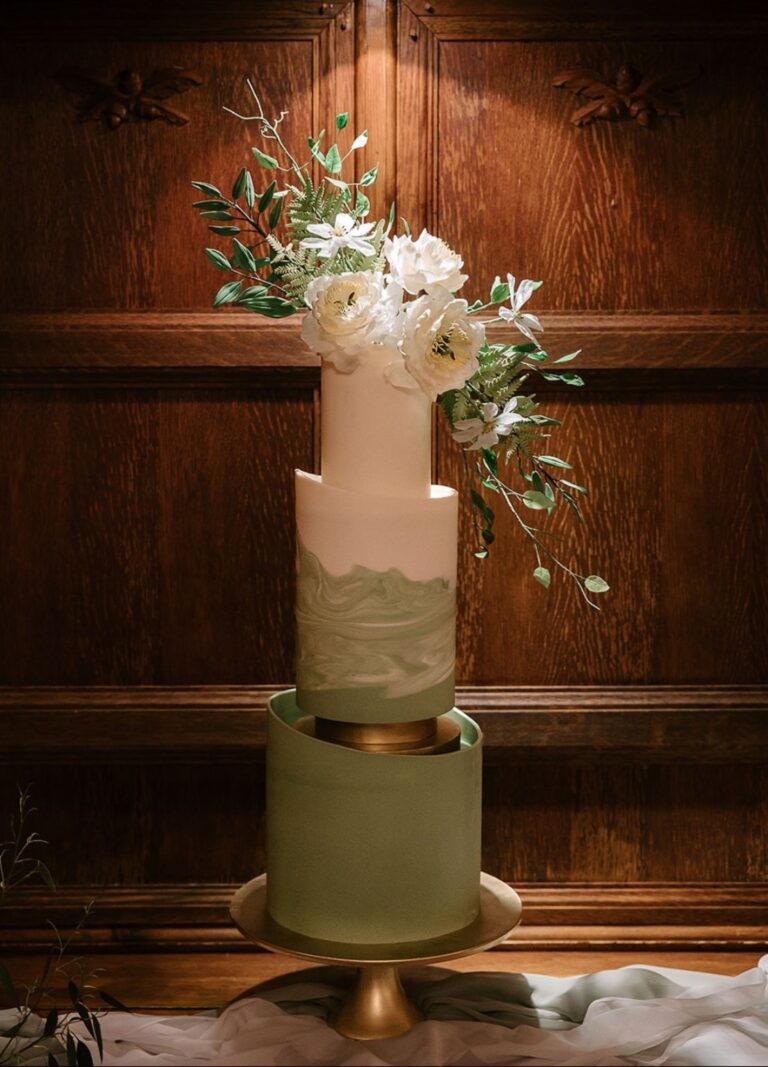A green and cream wedding cake with sugar flowers in a barn, Danielle's Cakes Pershore