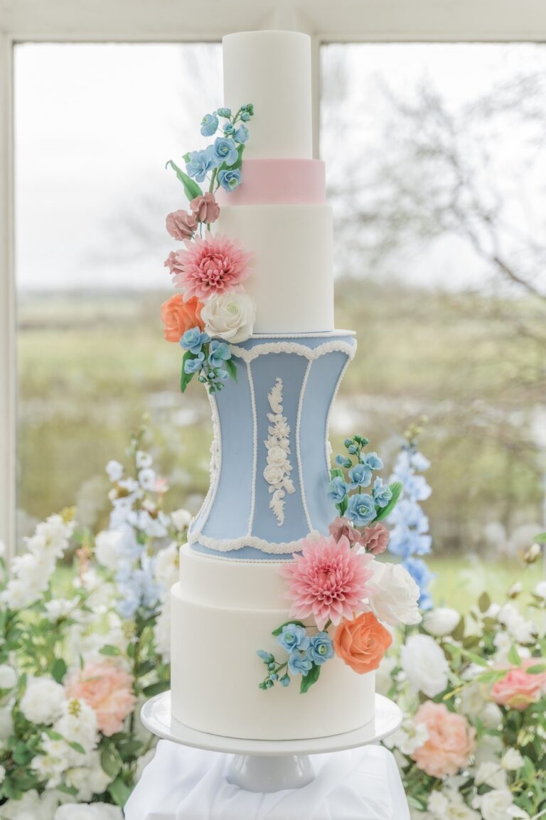 A tiered wedding cake with sugar flowers in a garden, Danielle's Cakes Pershore