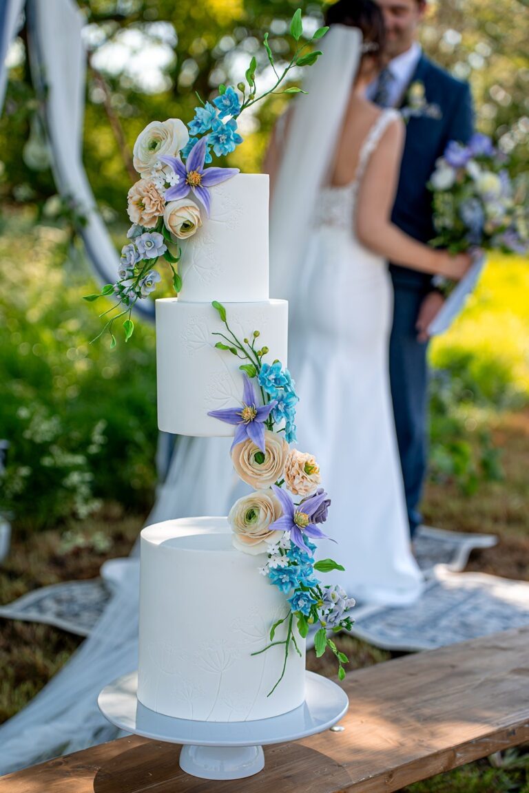 A wedding cake with blue sugar flowers at a wedding, Danielle's Cakes Pershore