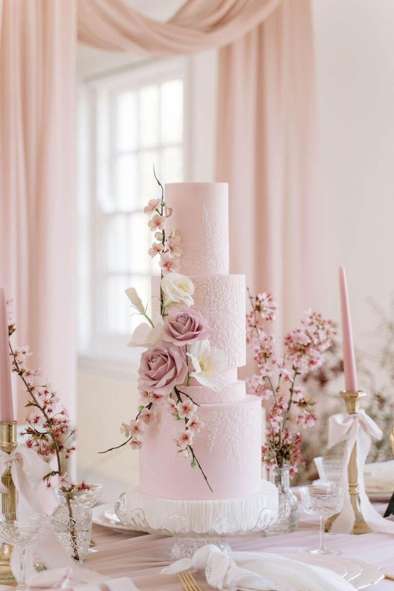 A tiered wedding cake with soft blue and peach sugar flowers, Danielle's Cakes Pershore