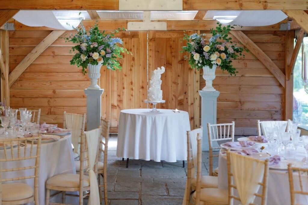 A wedding cake displayed in a barn venue, Danielle's Cakes Pershore