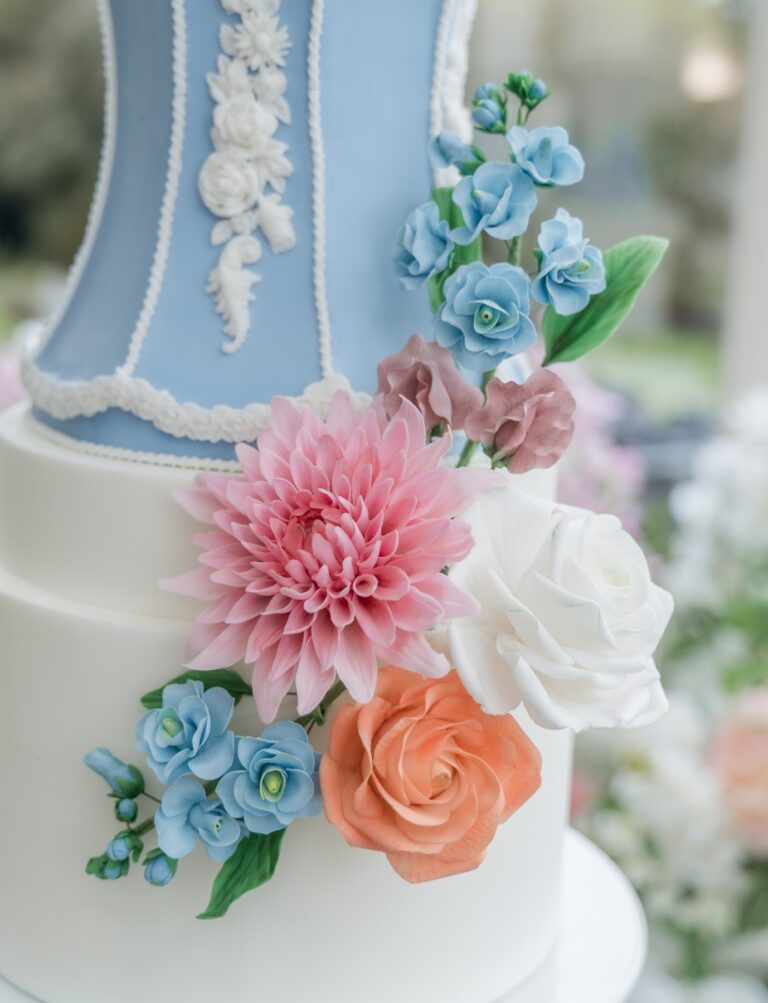 Close view of blue panels and sugar flowers on a wedding cake, Danielle's Cakes Pershore