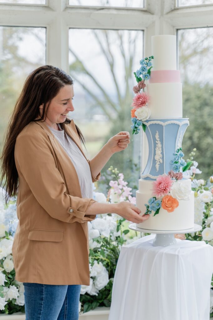 Danielle finishing a wedding cake at a venue, Danielle's Cakes Pershore