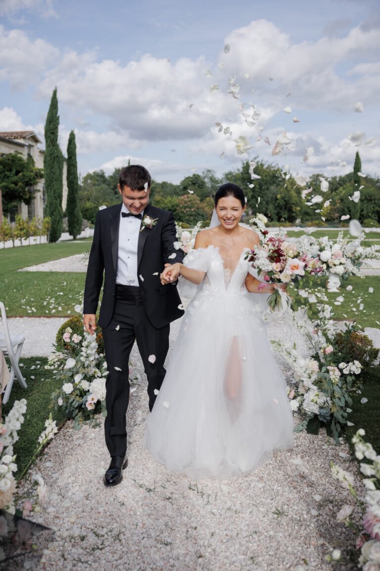 Couple walking through petals at their ceremony, Château Gassies, Bordeaux, France, Daria Events and Weddings